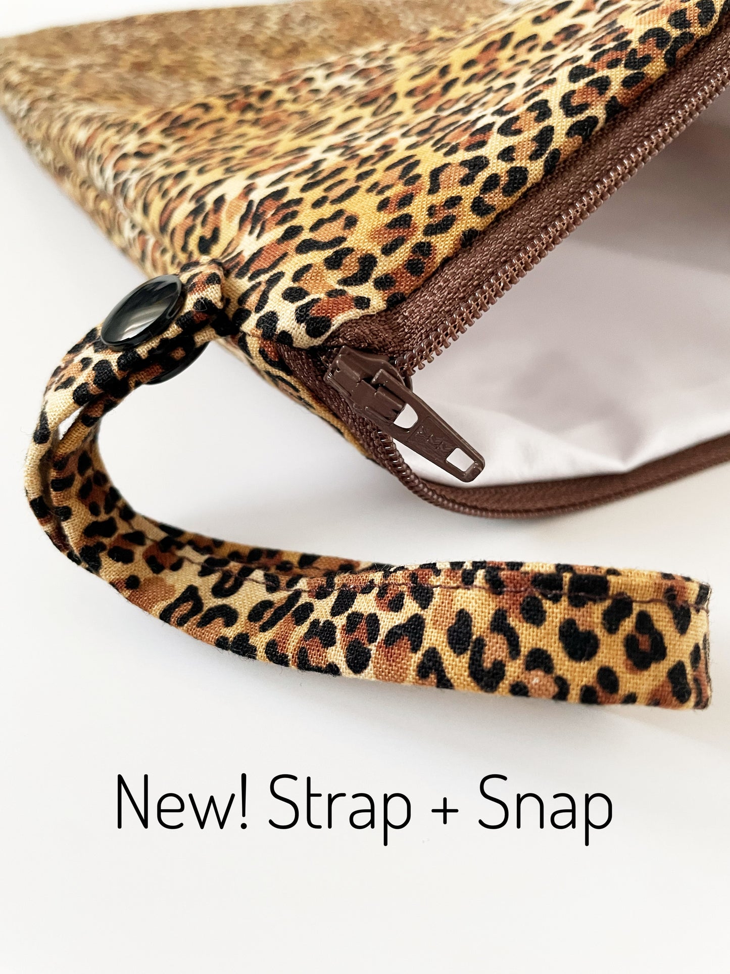 Cheetah print pouch with strap and snap closure on a white background