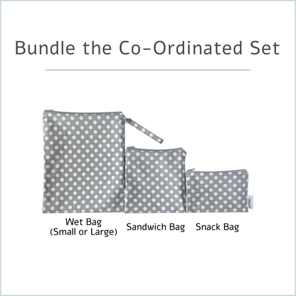Set of gray polka dot bags including a wet bag, sandwich bag, and snack bag on a white background.